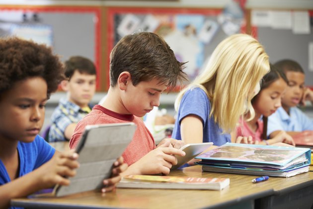 Pupils In Class Using Digital Tablet