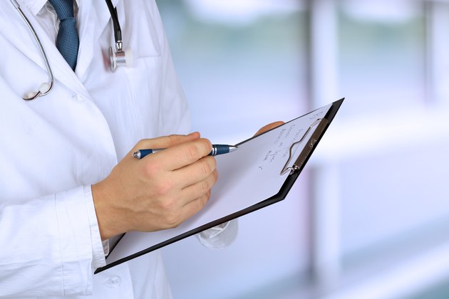 medical doctor with a stethoscope holding a black folder