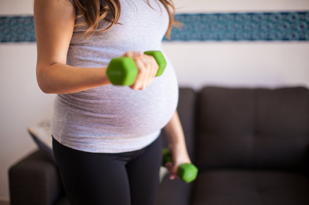 Pregnant woman lifting weights