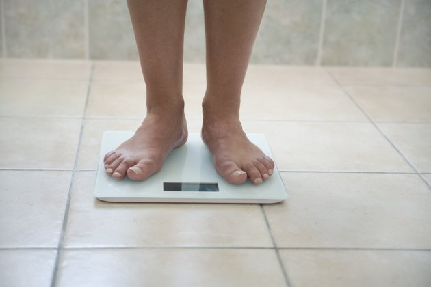 Man's feet on a weighing scale