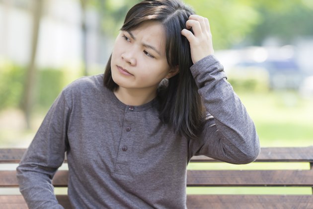 Woman Scraching Her Head at Park