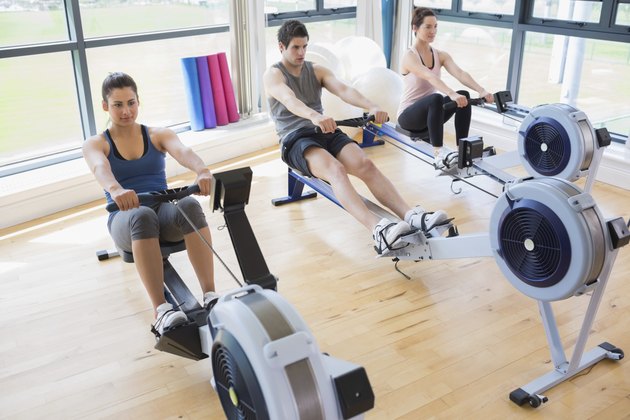 People using rowing machines
