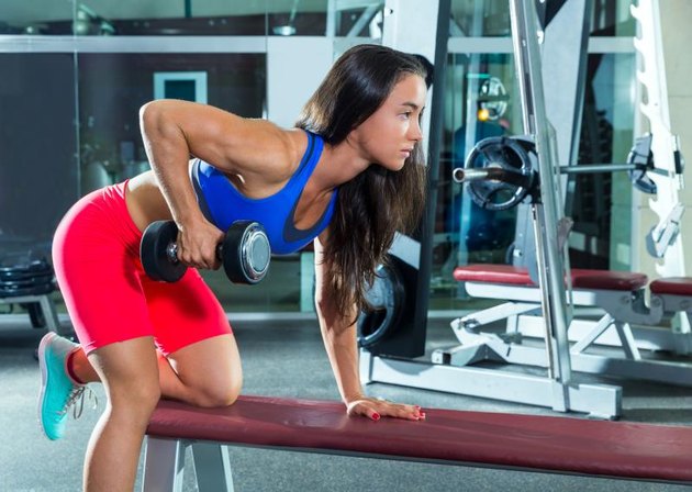 dumbbell triceps kickback girl workout exercise at gym