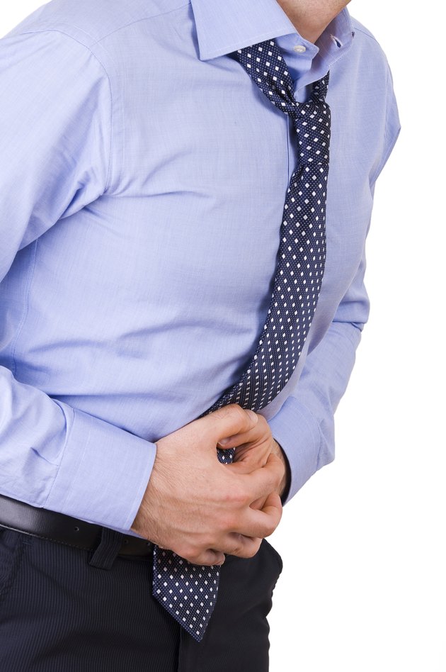 Businessman suffering from stomach pain.