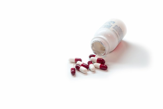 Medicine Bottle with Pills on White