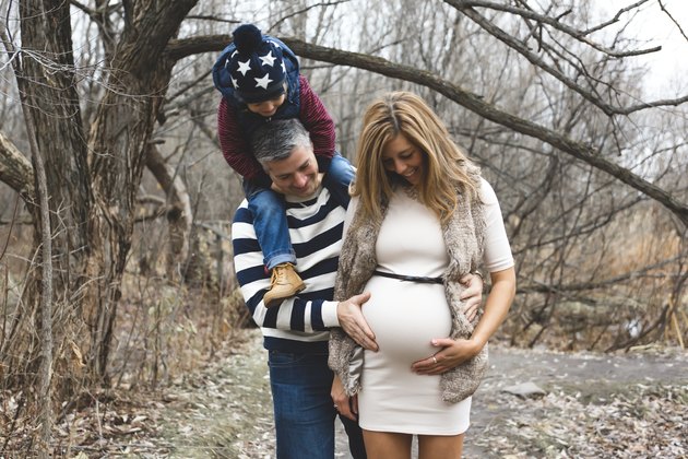 Beautiful outdoor pregnant couple portrait in autumn nature