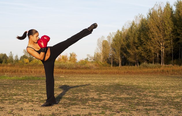 Kick boxing girl exercising in the nature
