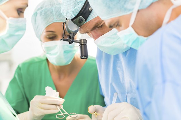 Surgeons operating patient in operation theater