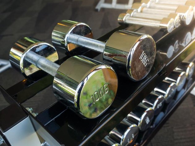 Row of heavy dumbbells in sport gym for strong healthy