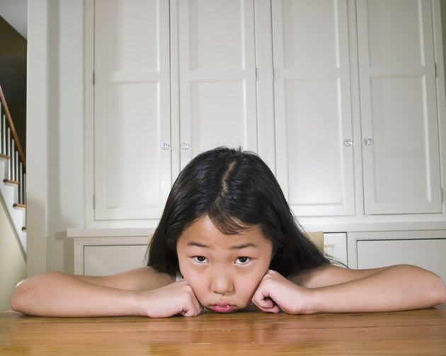 Portrait of girl (8-9) leaning on table