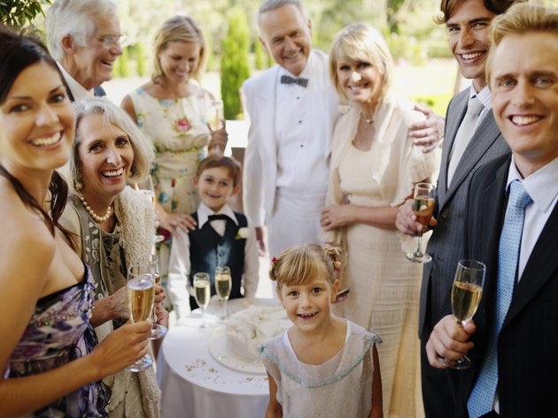 "Bride and groom with guests, smiling, portrait"