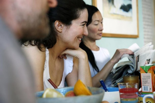 Three friends sitting at table.