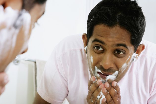 Close-up of a young man washing his face