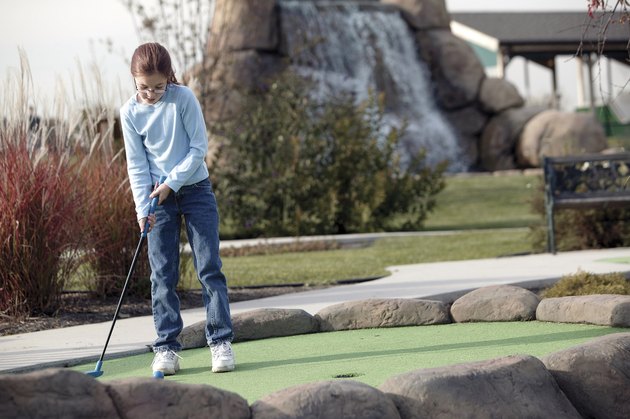 Girl practicing golf
