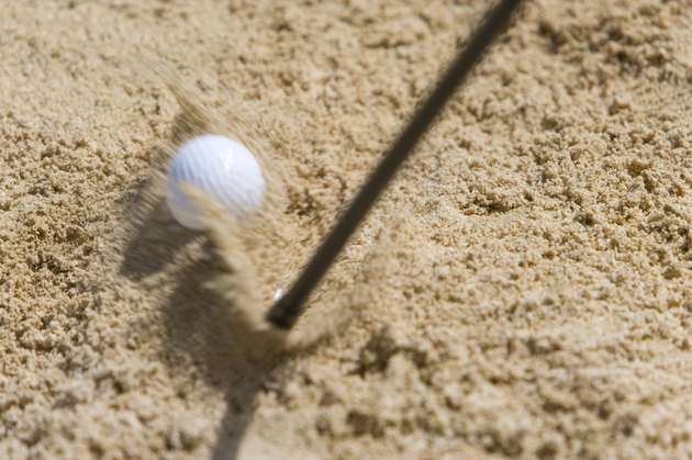 Golf club hitting ball on sand, blurred motion, Saipan, USA