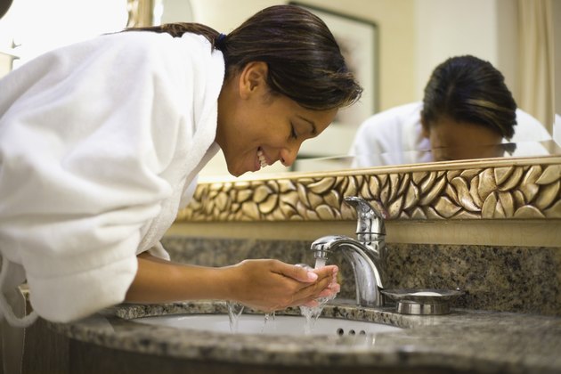 Young woman washing face