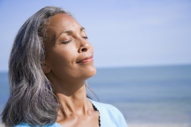 Close-up of a mature woman smiling with her eyes closed