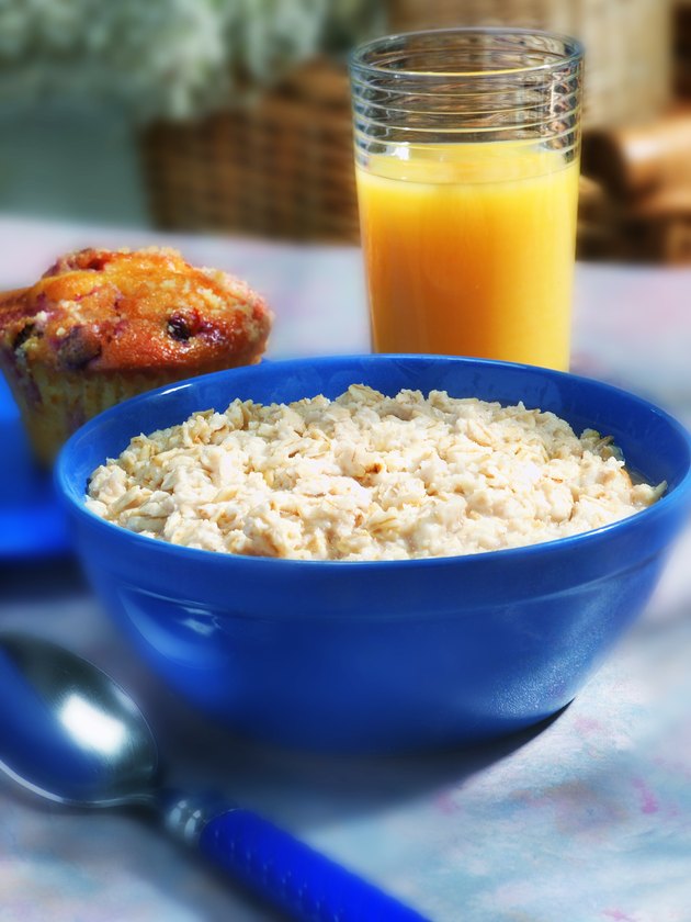 Photo, bowl of oatmeal, muffin and a glass of orange juice, Color, High res