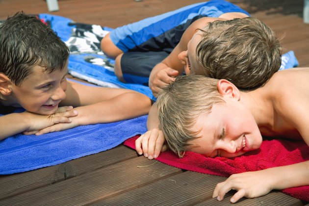 Boys lying on towels