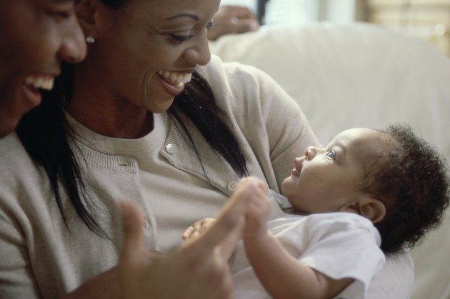 Close-up of parents looking at their son and smiling