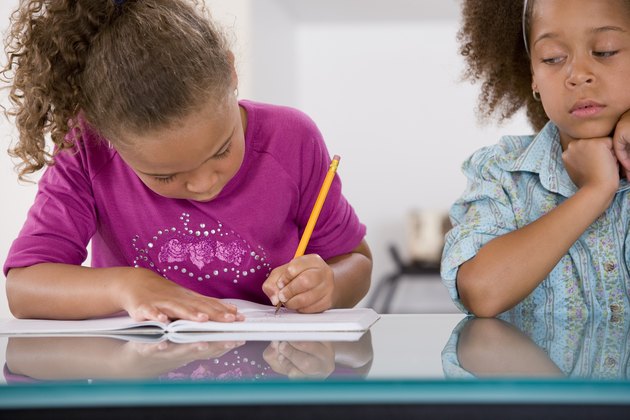 Little girl cheating off classmate