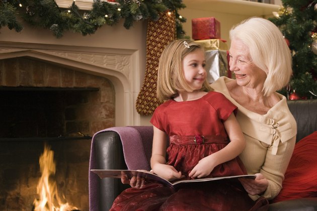 Grandmother and girl reading book at Christmas