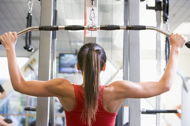 Woman Weight Training At Gym