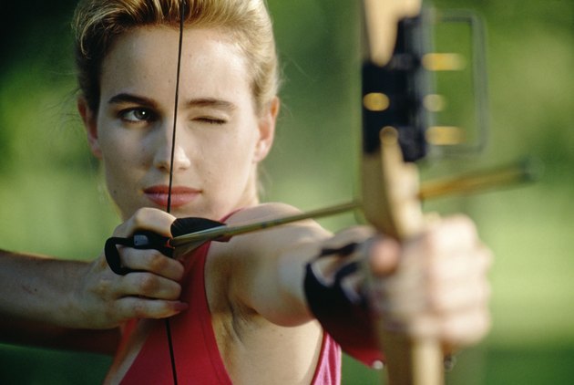 Woman aiming bow and arrow