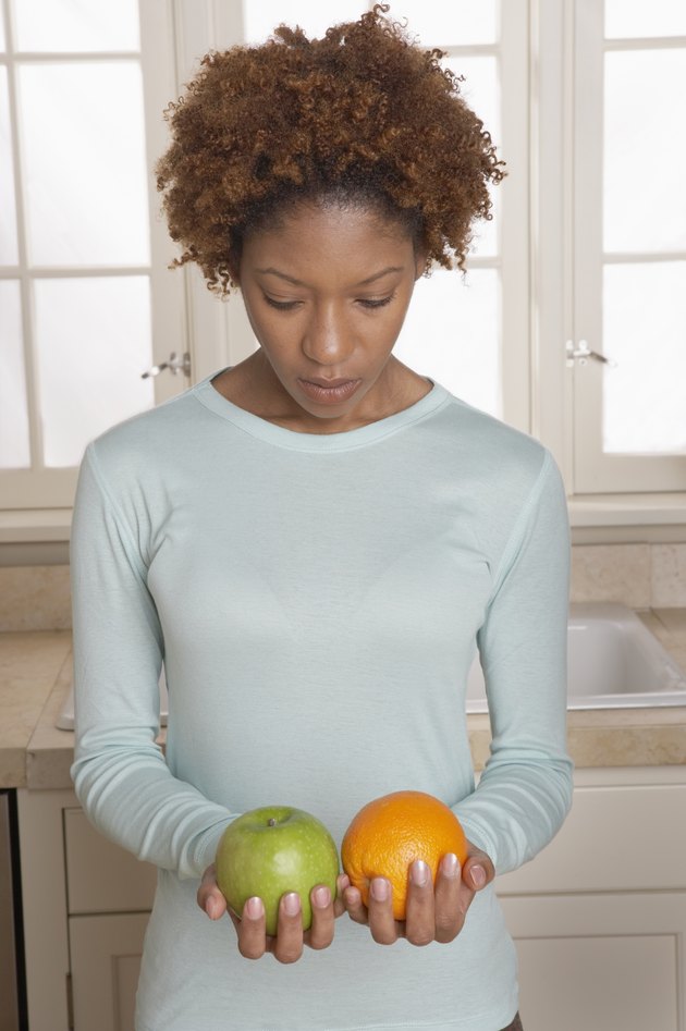 Mid adult woman holding fruits