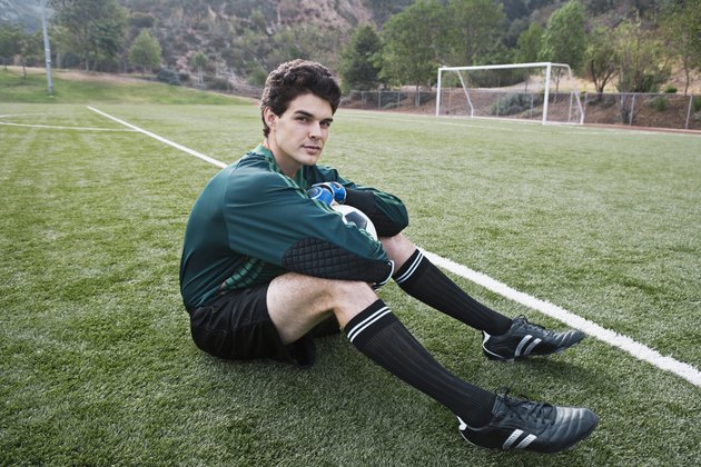 Soccer player sitting on field