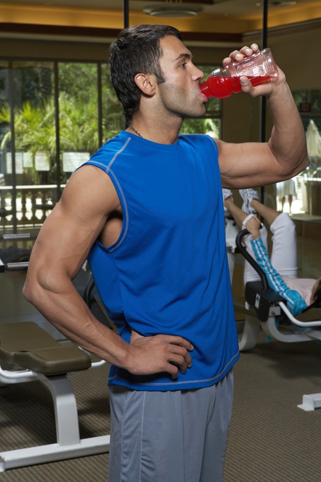Man drinking juice, looking away, side view