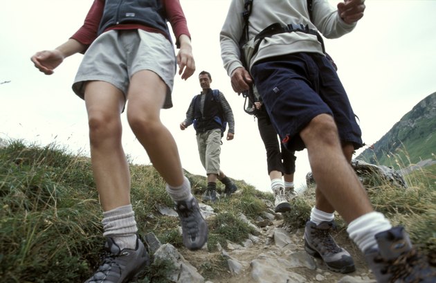 Men and women hiking down mountainside