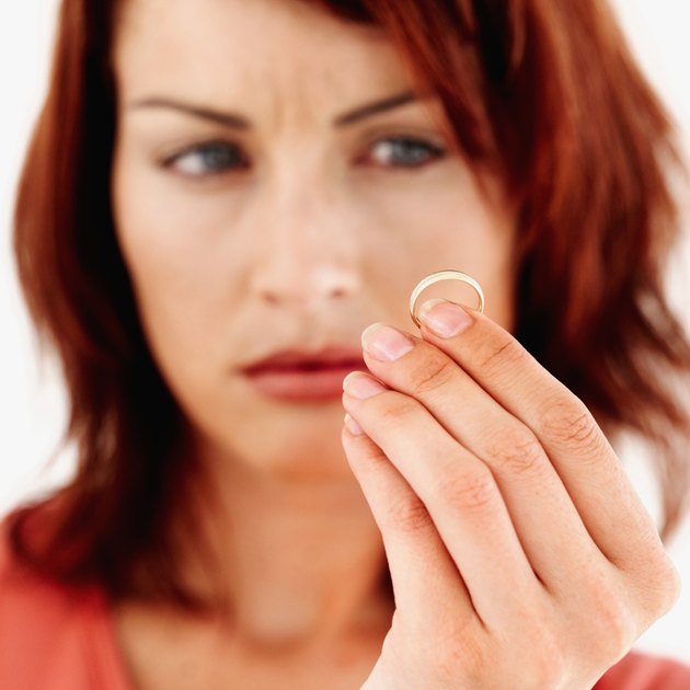 Young woman looking at a ring in her hand