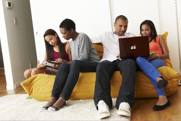Mixed-race family at home on sofa