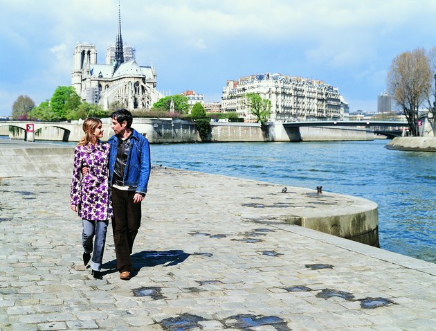 Young Couple Walking on the Left Bank of the River Seine, Notre Dame in the Background