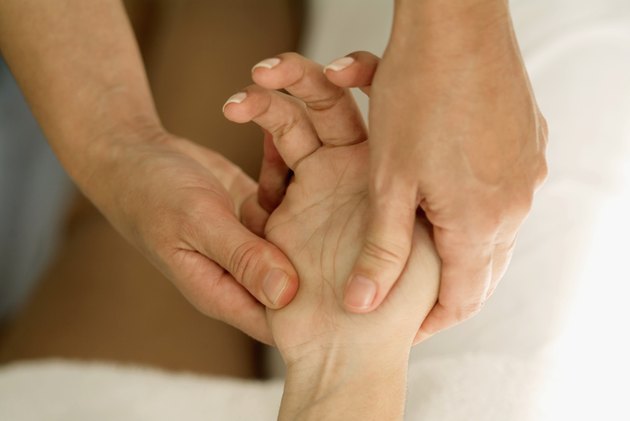 Person massaging a hand