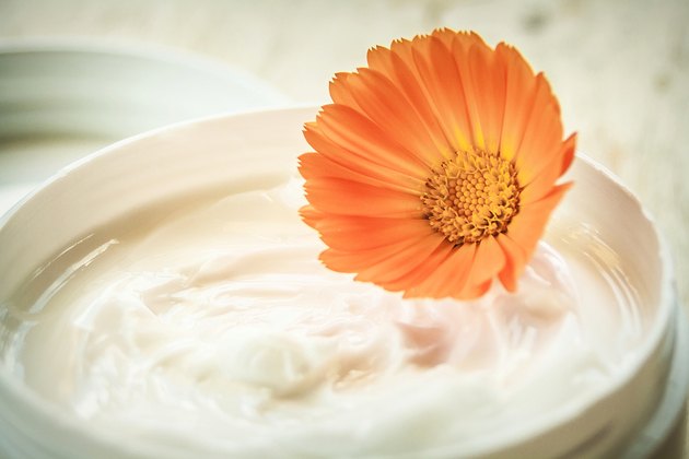 Moisturizing cream and marigold flower
