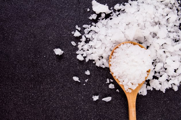 salt crystals on black stone plate background