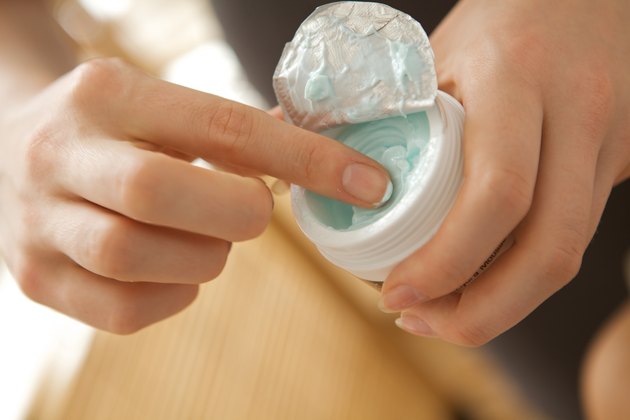 Close-up of woman holding facial cleanser