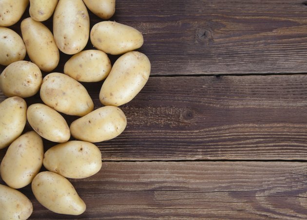 Frame of potatoes on old wood II