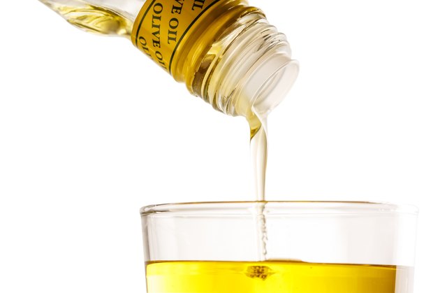 Pouring olive oil from bottle