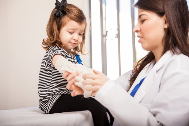 Hurt little girl getting a bandage