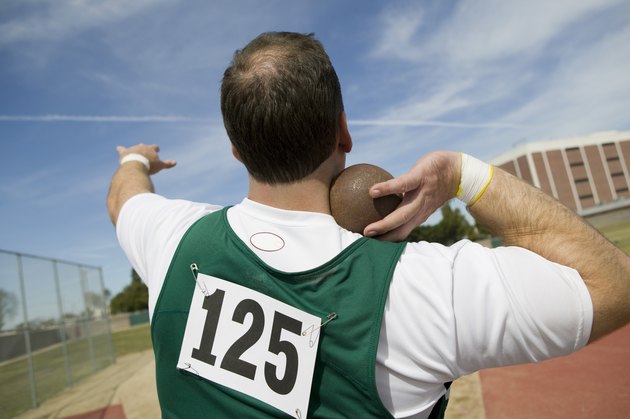 Male shot putter holding shot