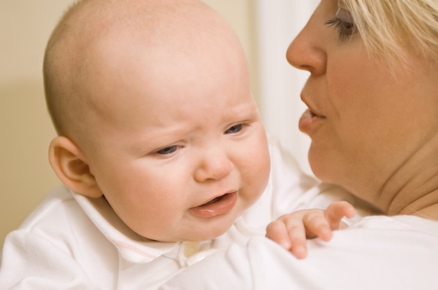 Mother holding upset baby