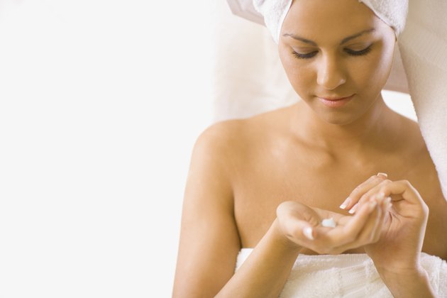 Young woman looking at lotion