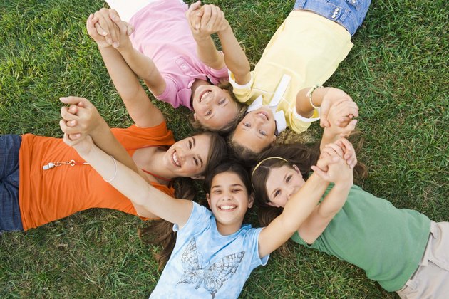 Camp counselor and girls lying down
