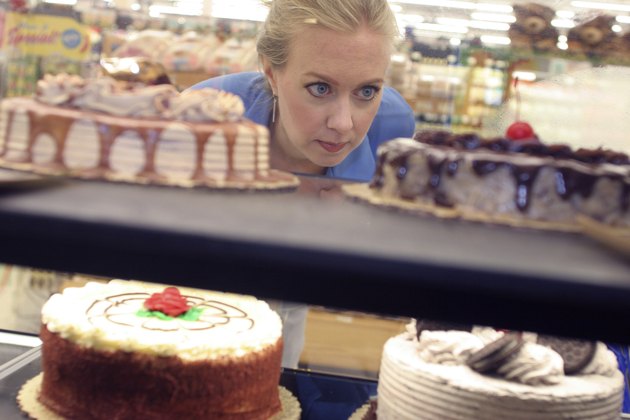 Mid adult woman looking at cakes in a supermarket