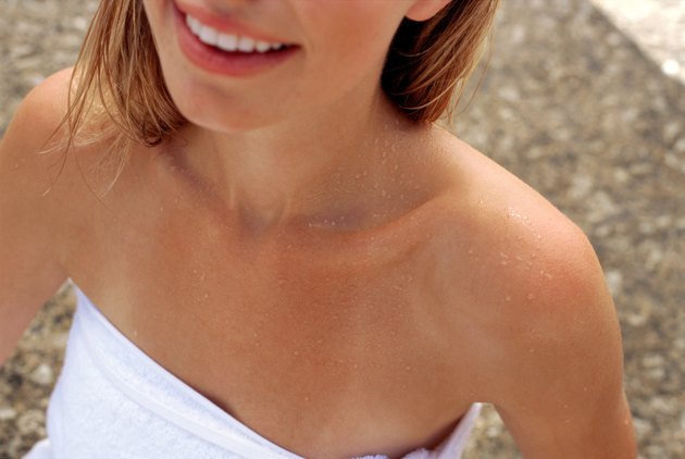 Shoulders of woman wrapped in towel