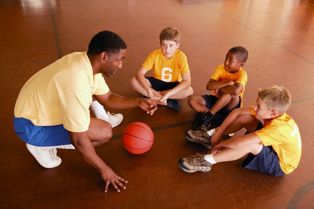 Boys with basketball coach