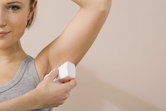 Woman applying deodorant